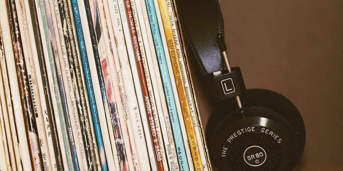 A vinyl record and sleeve on a table under directional light.