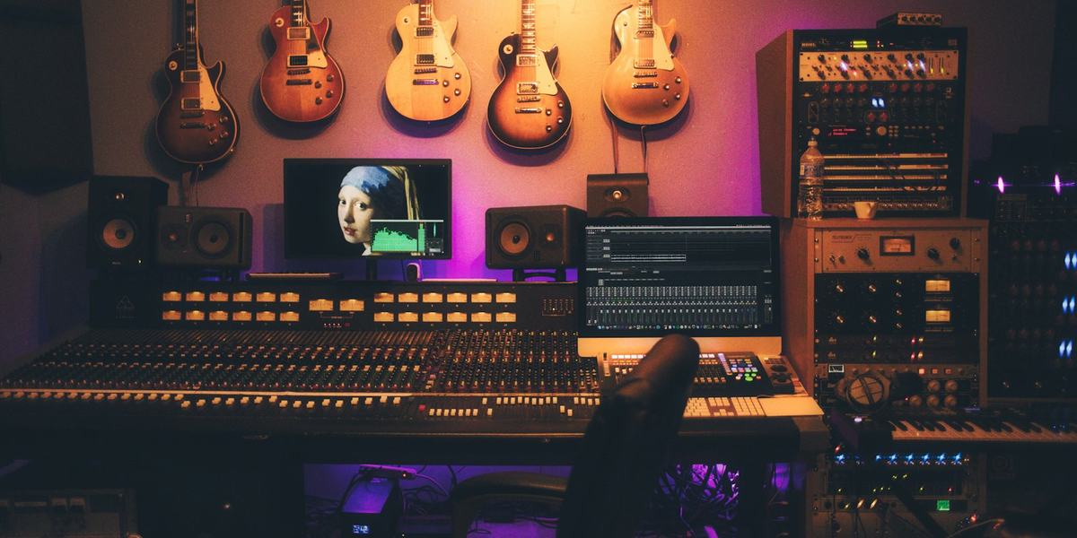 A studio desk with two sets of monitors, used to compare two takes of the same song.